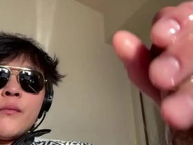 Asian man pleasuring himself and taking a selfie.