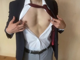 A gay Japanese man masturbates while wearing a suit.
